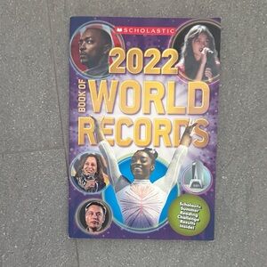 Small Scholastic 2022 World Records Book with Purple and Yellow Cover